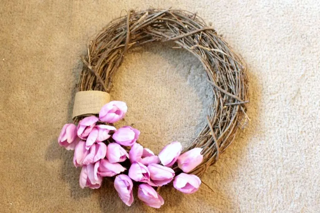 how to make a spring wreath - place tulips half way around the bottom of the grapevine wreath