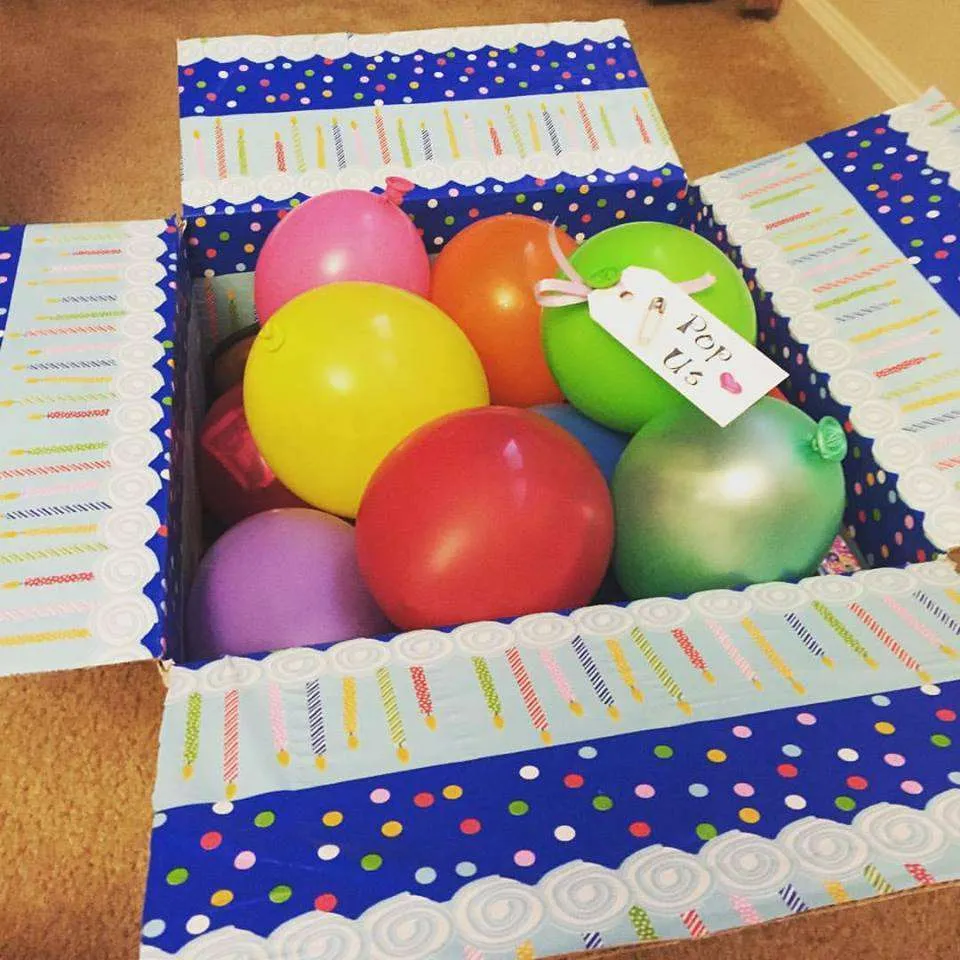 kids birthday care package with balloons filled with money and toys that say 'Pop Us'