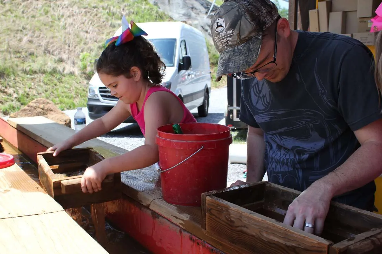 Girl and her dad mining for gems during a weekend in Pigeon Forge, Tennessee.