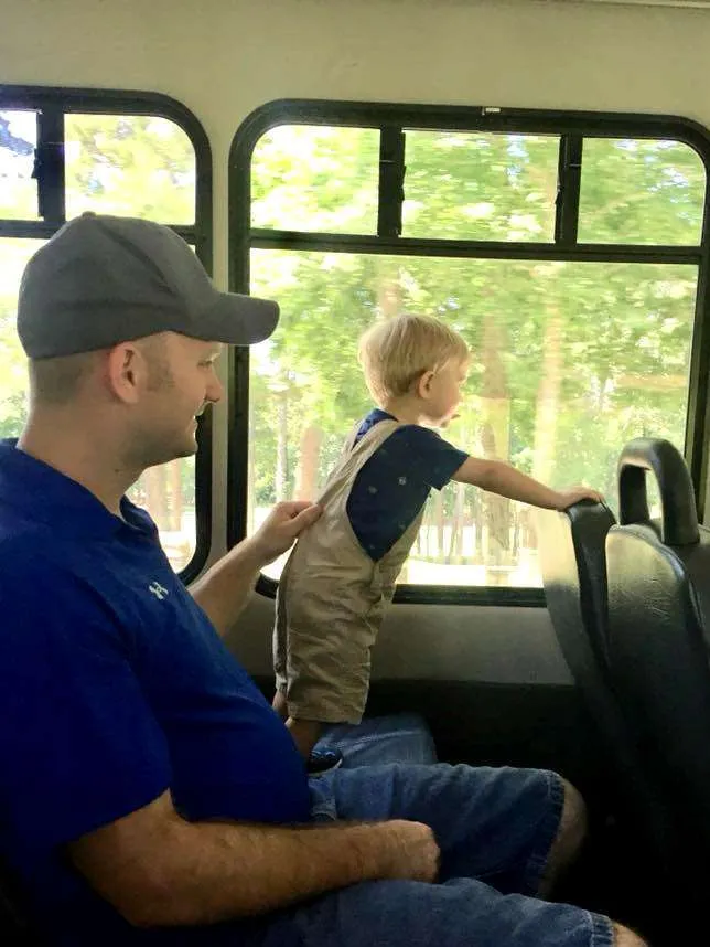 Father and son using free shuttle service at Stone Mountain.