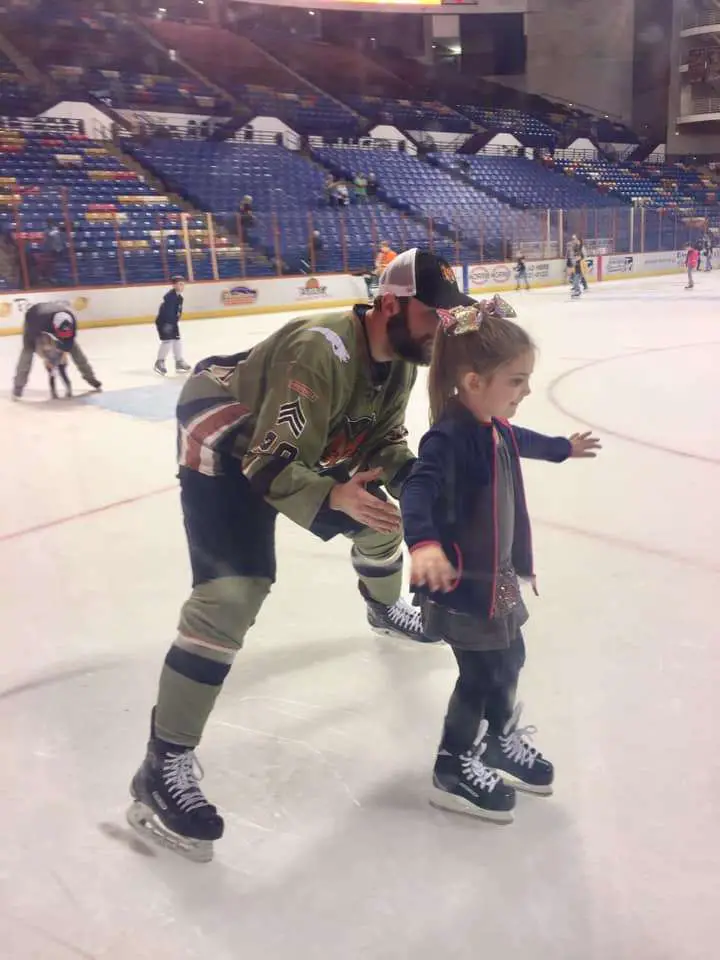 Girl skating with the players after the Marksmen Hockey Game in Fayetteville, NC. | Fayetteville Bucket List