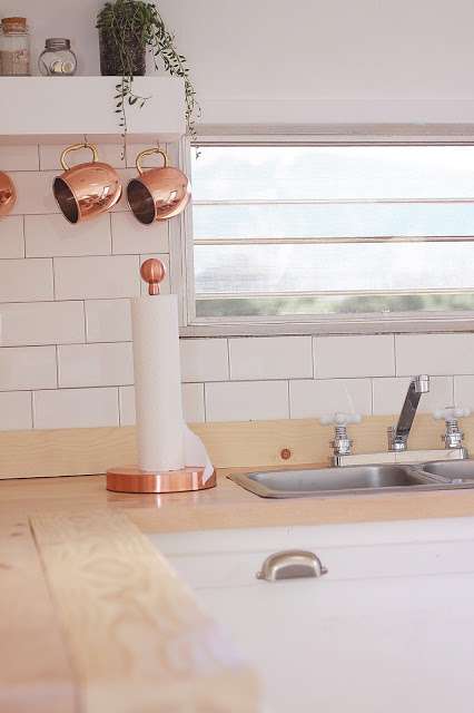 Gold or copper accents are perfect for farmhouse camper interiors.
