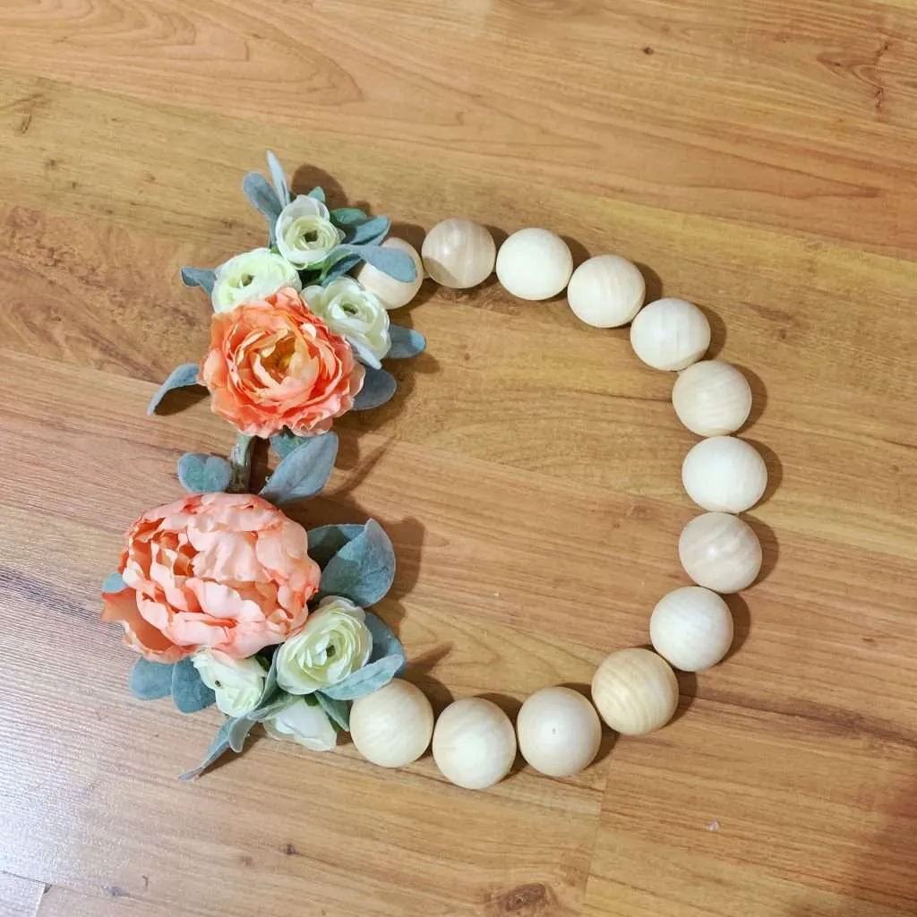 Step 4: Add flowers to your DIY wood bead wreath.