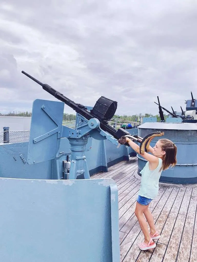 Pretending to shoot the guns on the ship.