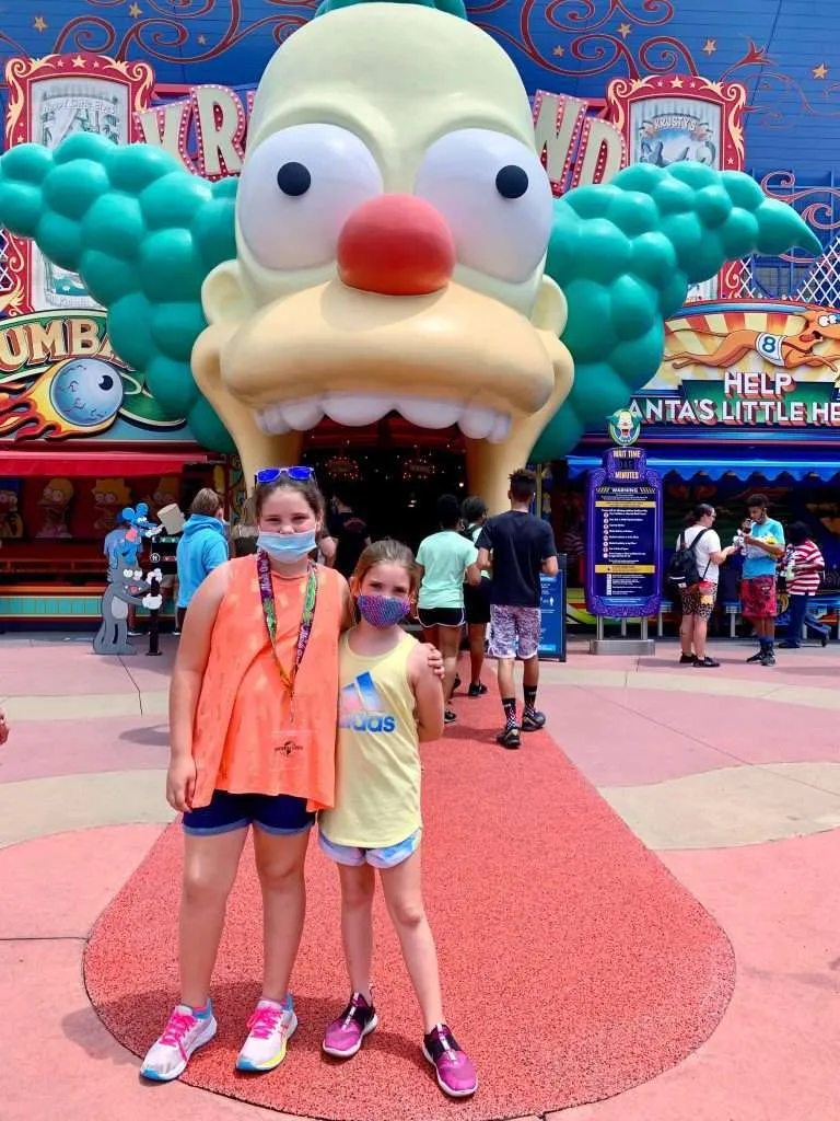 Girls standing in front of The Simpson ride at Universal Orlando.