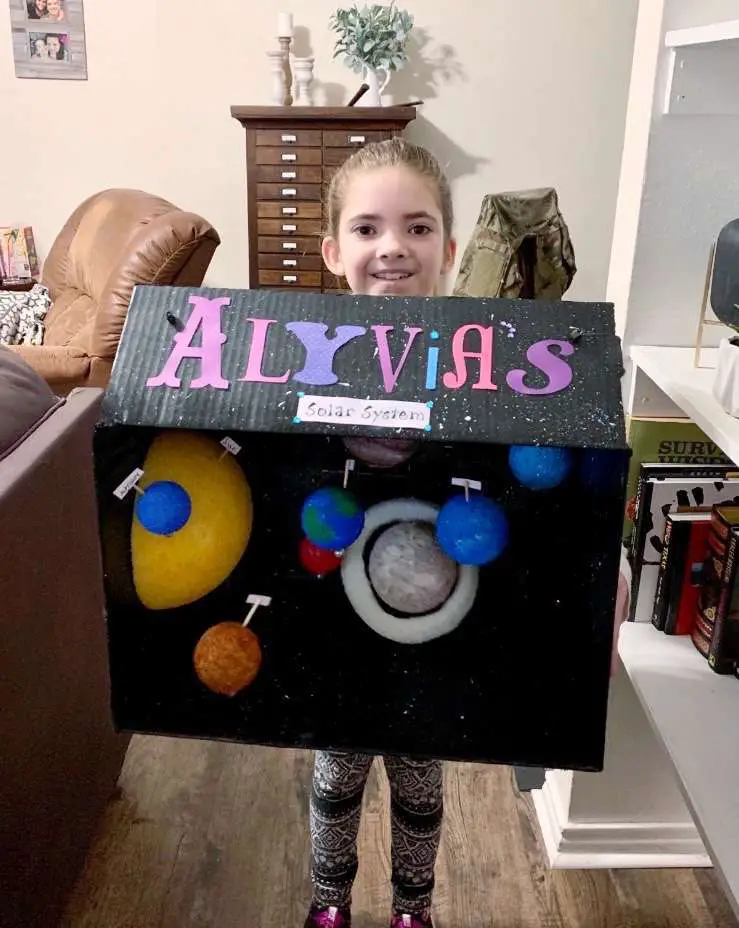 Taking her model solar system to school!