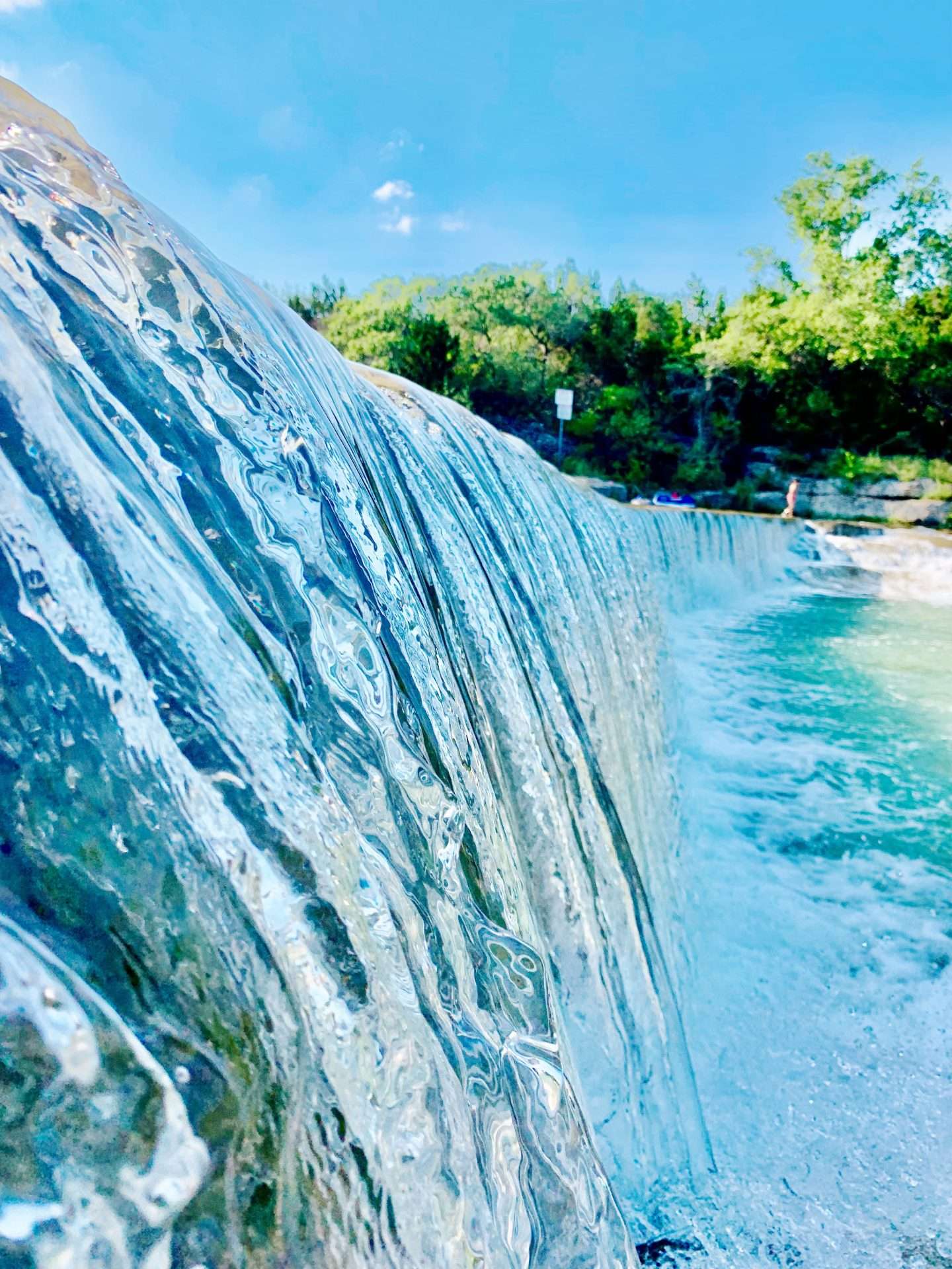 Water flowing over the dam at Blue Hole Park in Georgetown, Texas.