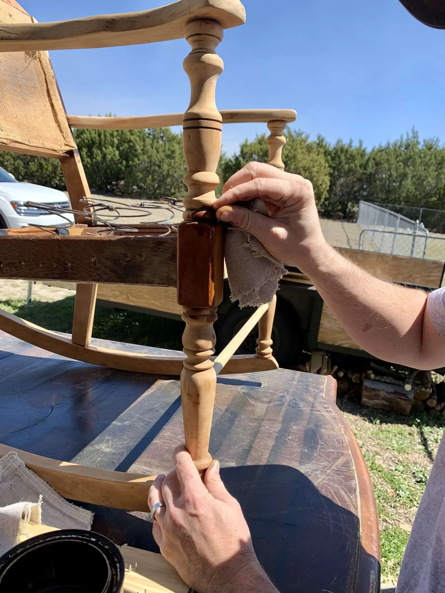 Staining the wood of an antique rocking chair.