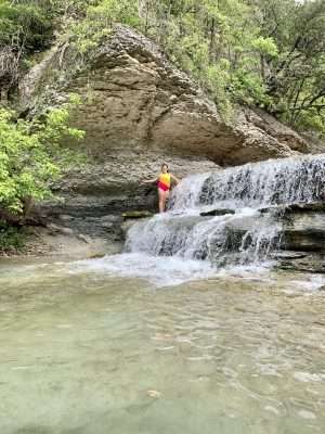 Playing in the waterfall in Belton, Texas.