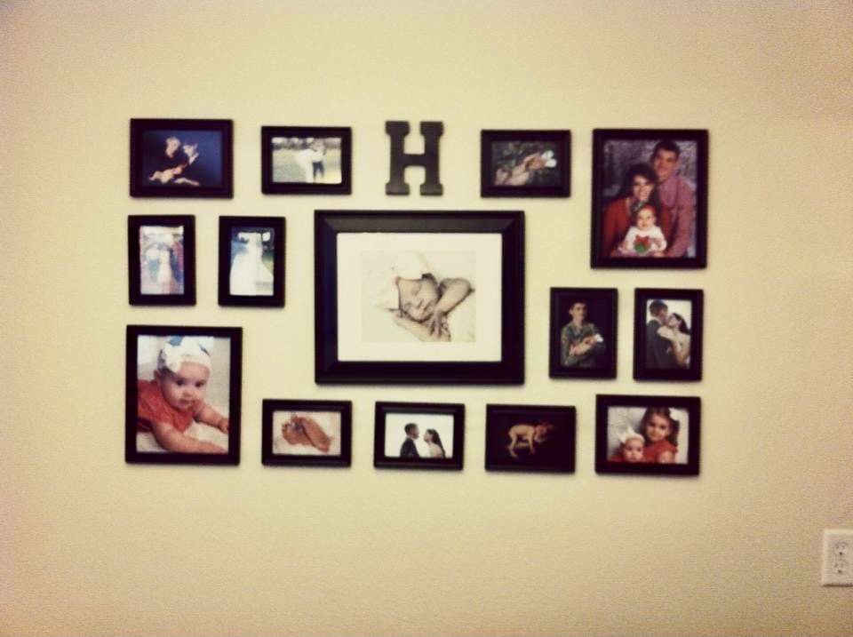 Family photos gallery wall using Wal-Mart picture frames.