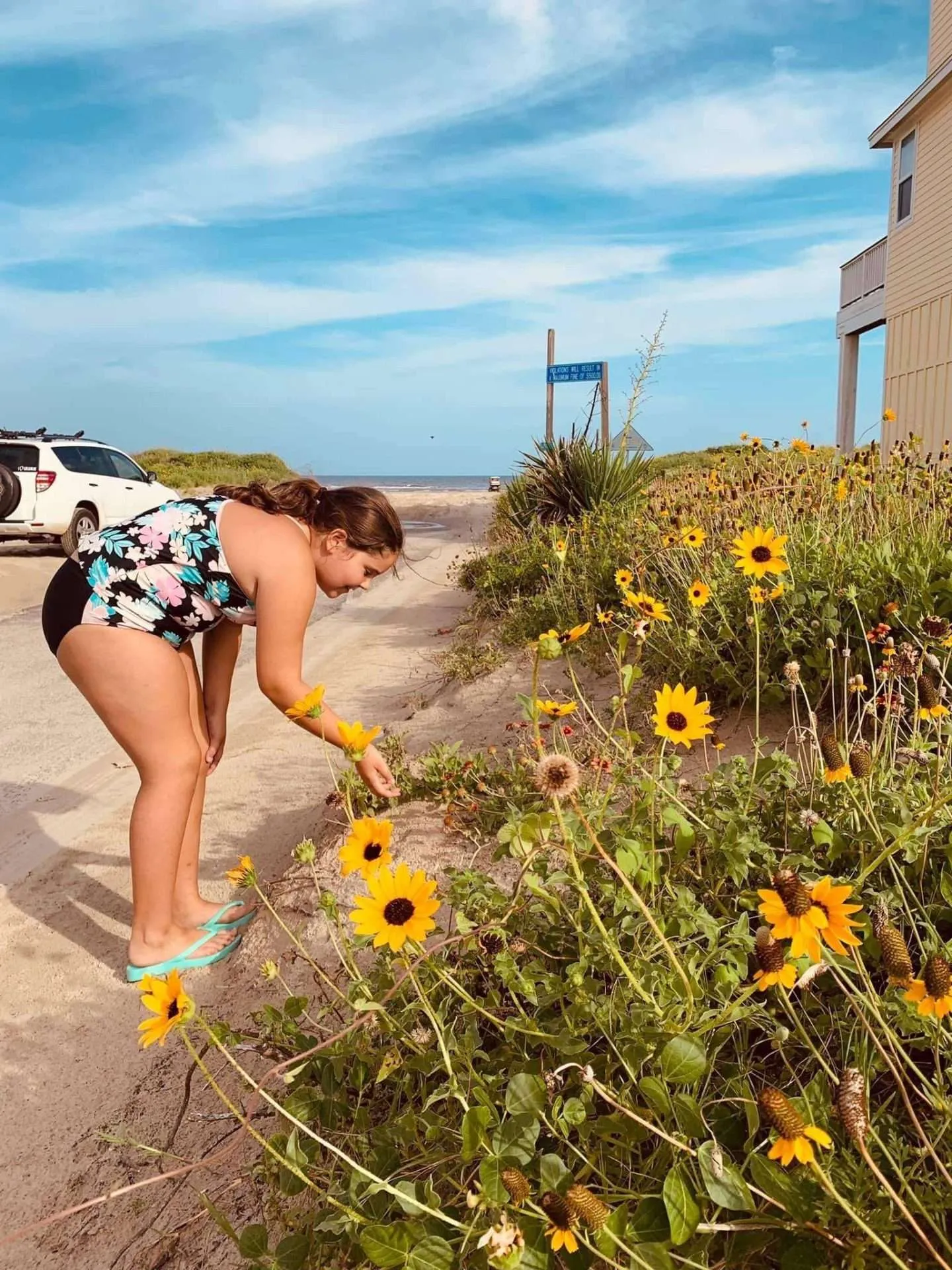 Taking the time to stop and smell the flowers at the beach in Galveston, Texas.