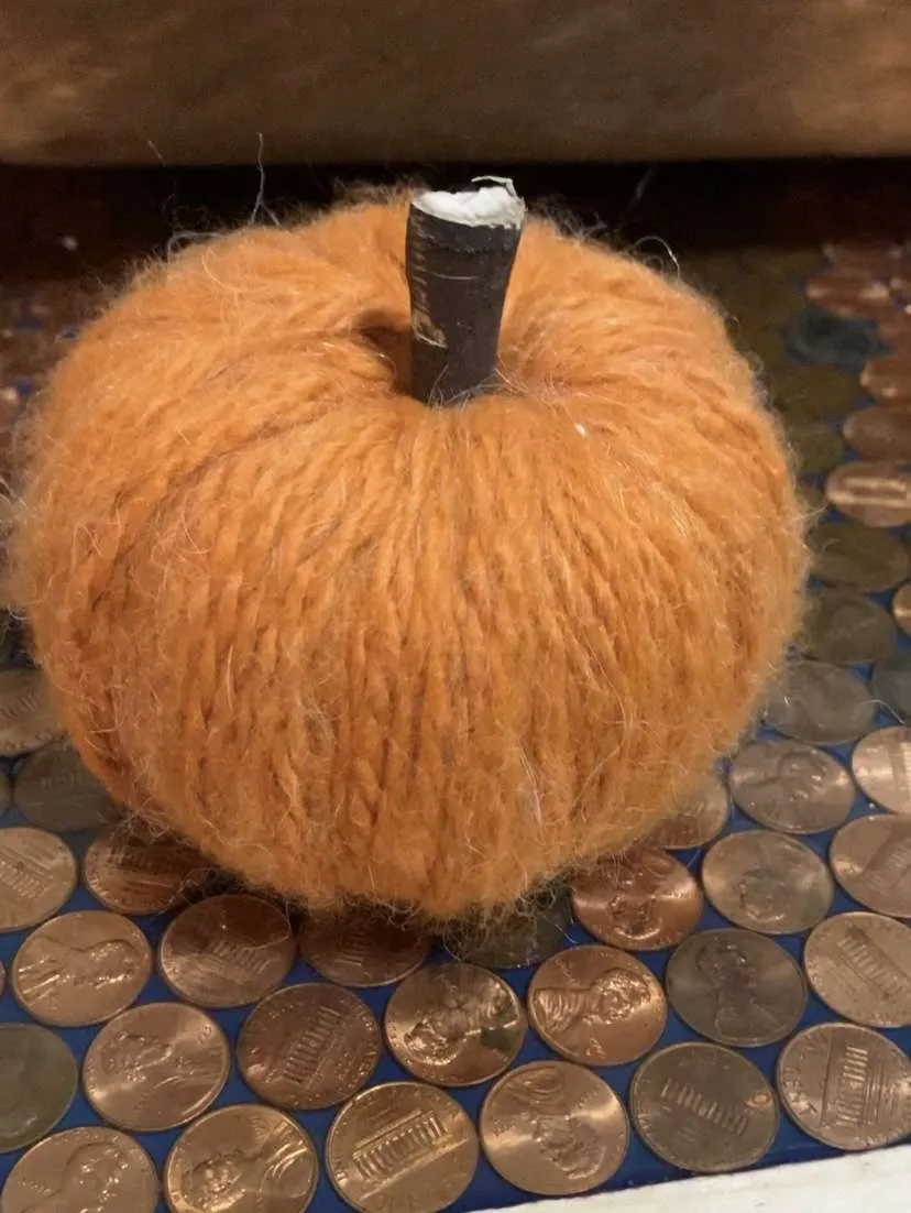 The last step to making these yarn-wrapped pumpkins is adding the stem on top.