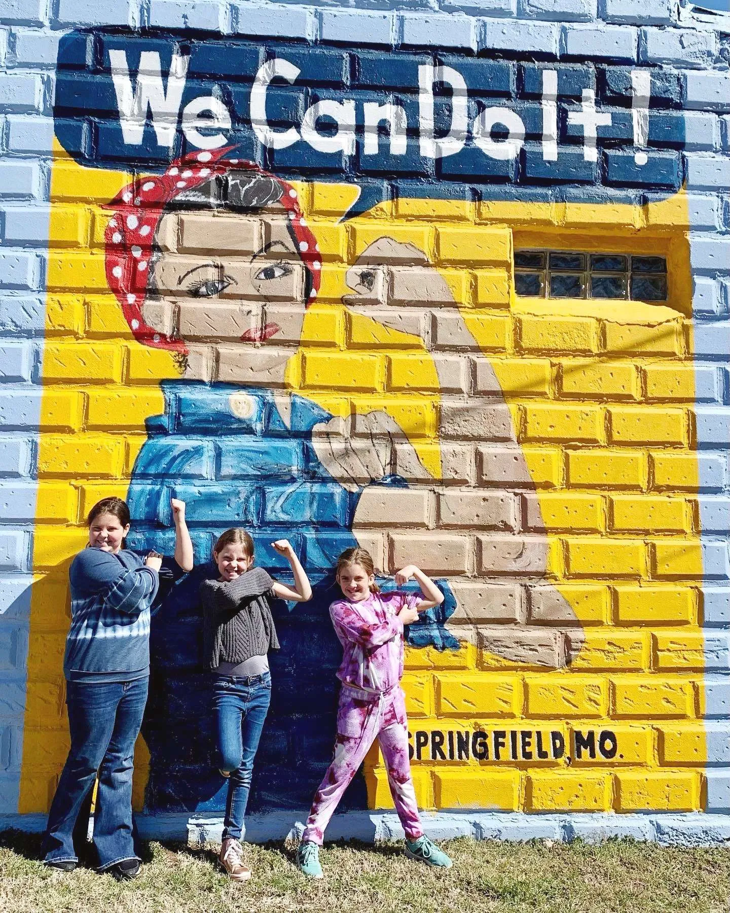 girls posing with Rosie the Riveter mural in Springfield, Missouri