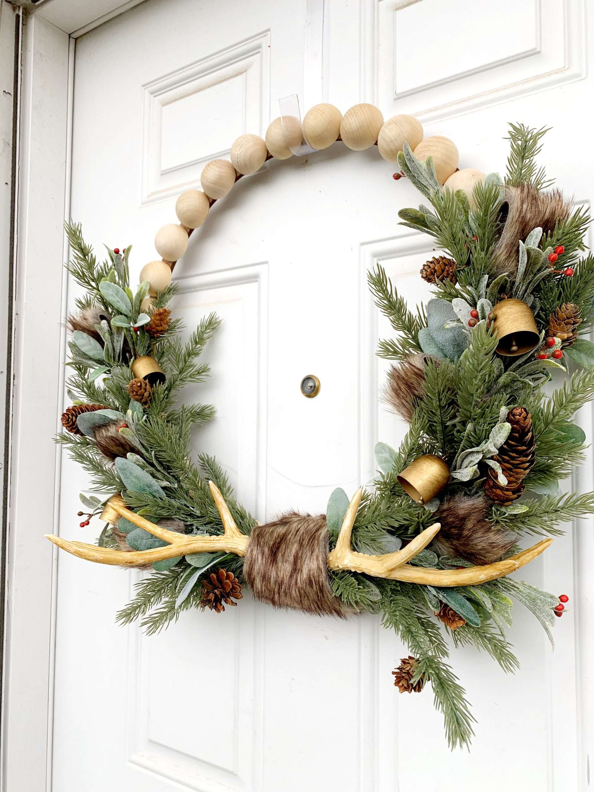 How to make a rustic wood bead Christmas wreath with antlers and bells.
