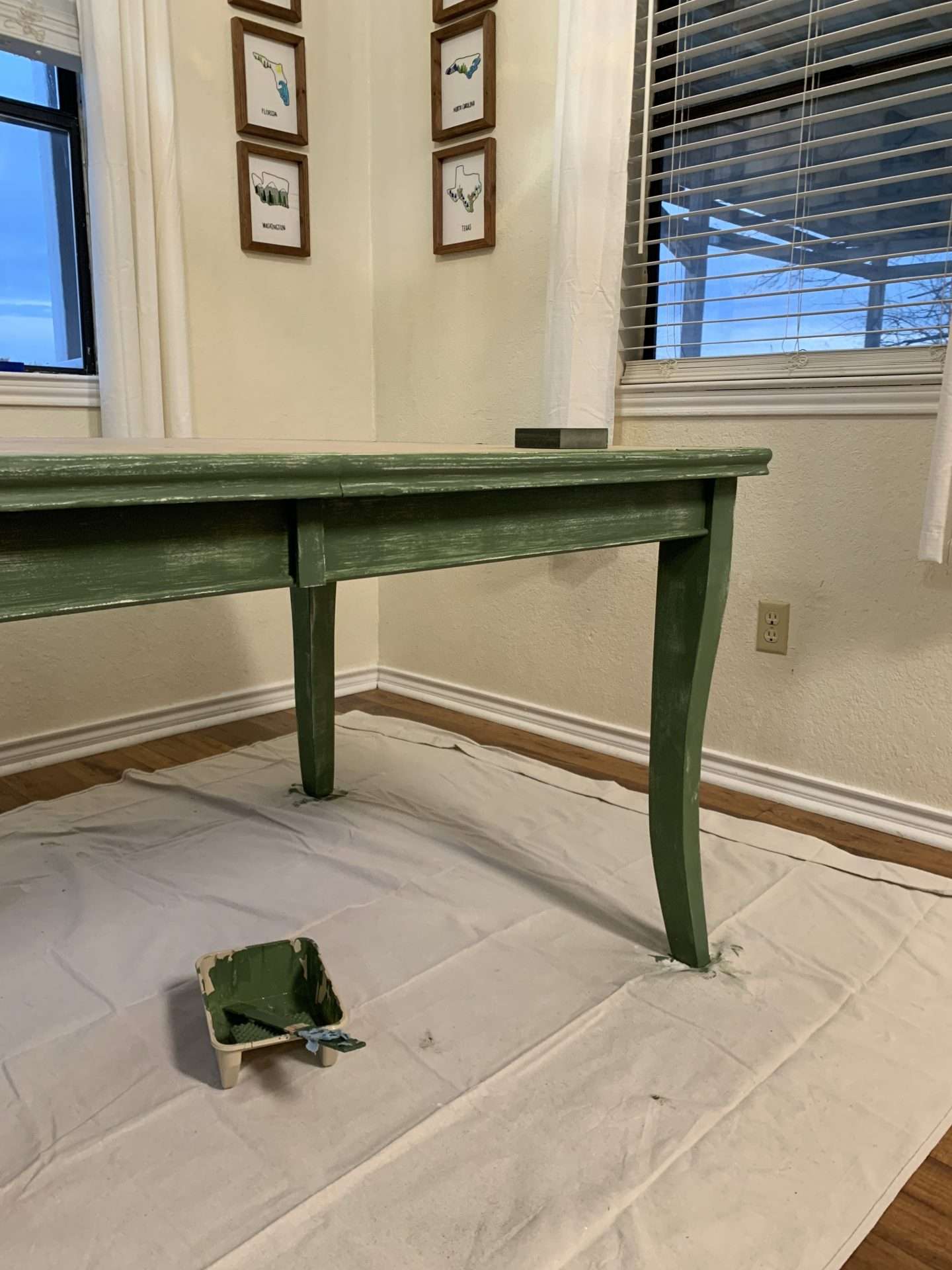 Painting a dining room table after 1 coat of paint.