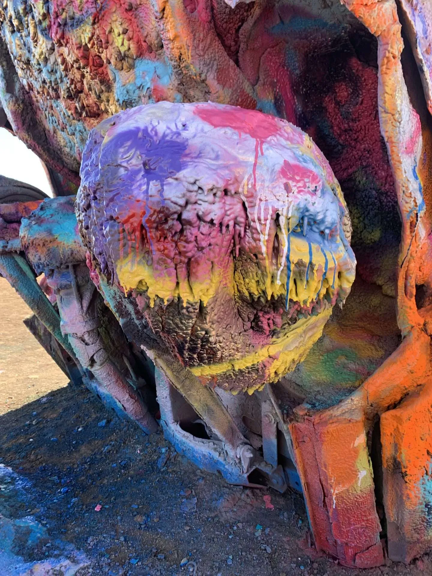 Thousands upon thousand of layers of paint cover the cars at Cadillac Ranch.