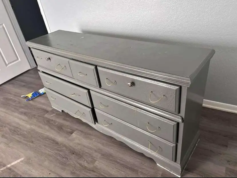 Before picture of gray dresser before it is refurbished.