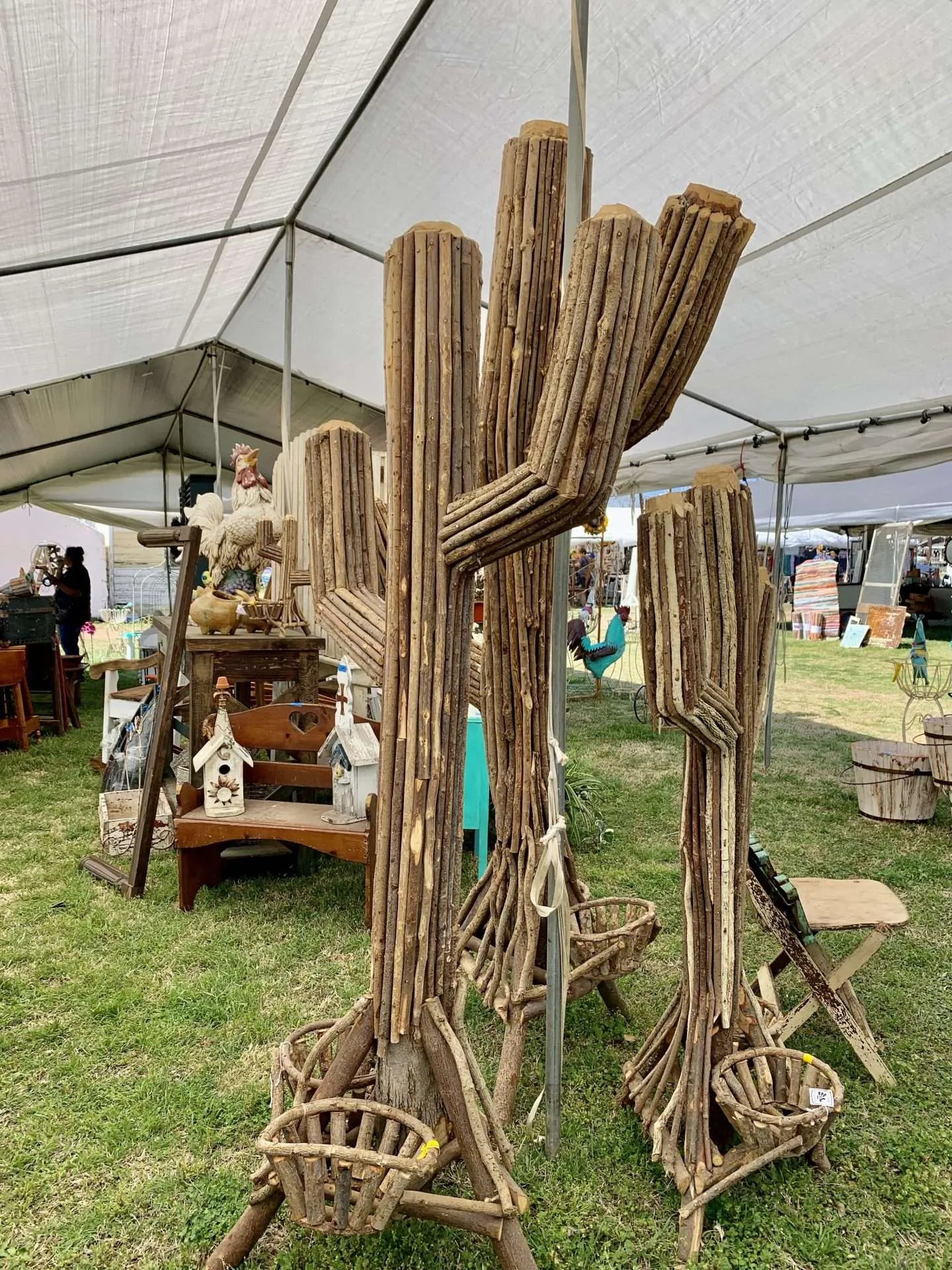 Wooden cacti for sale at the fields in Warrenton, TX during the Round Top Antique Show.
