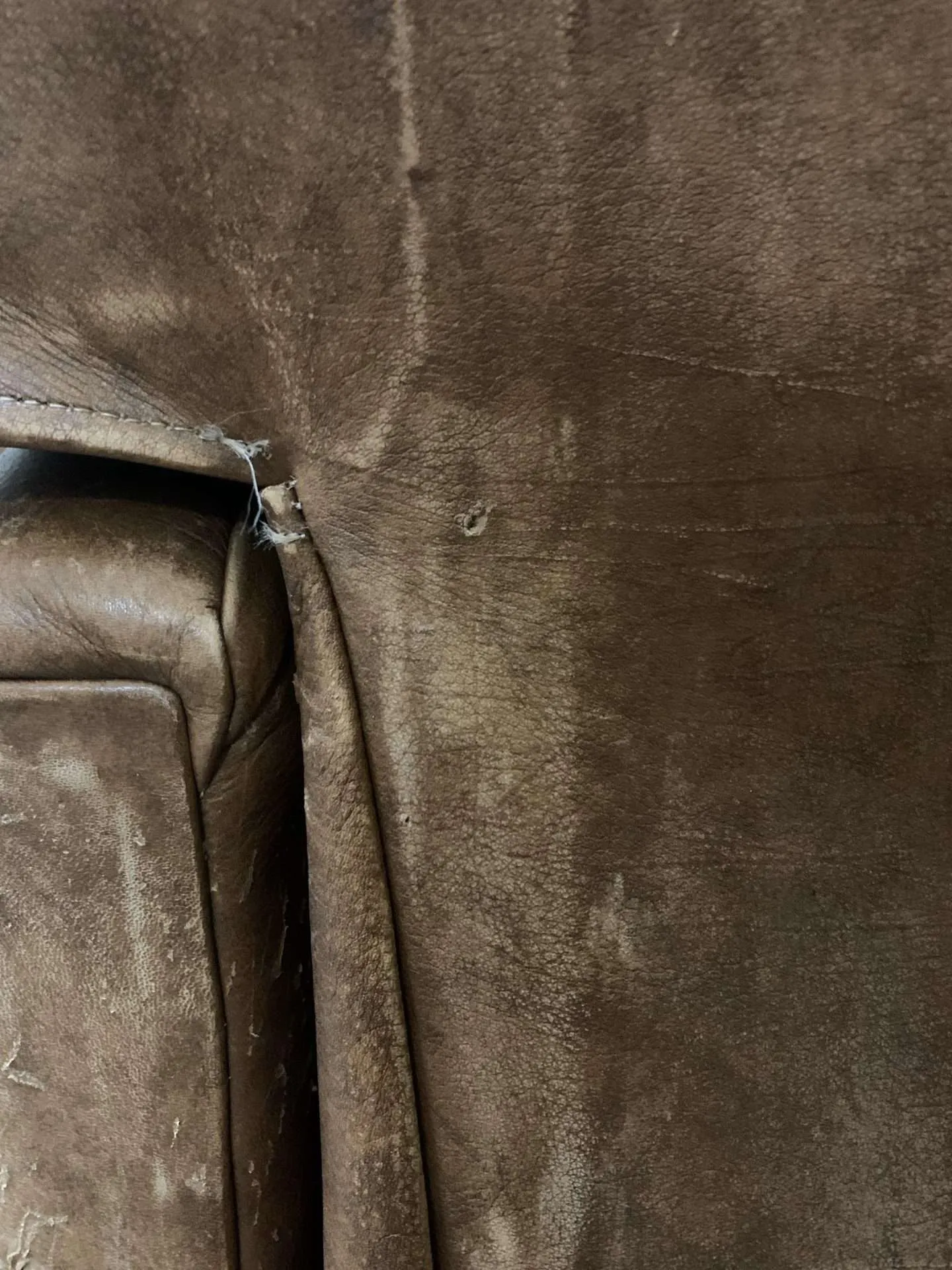 Filling in a hole in a leather chair.