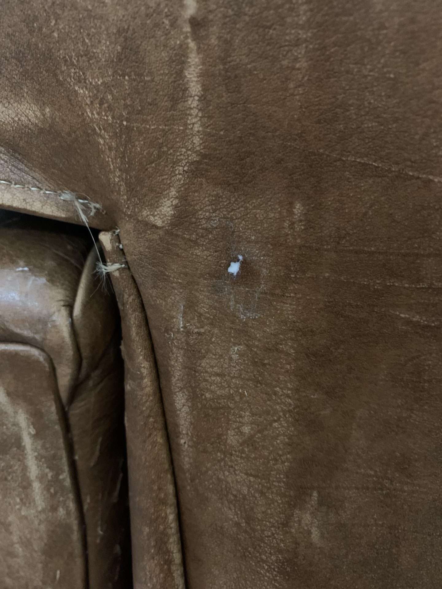 Filling in a hole in a leather chair.