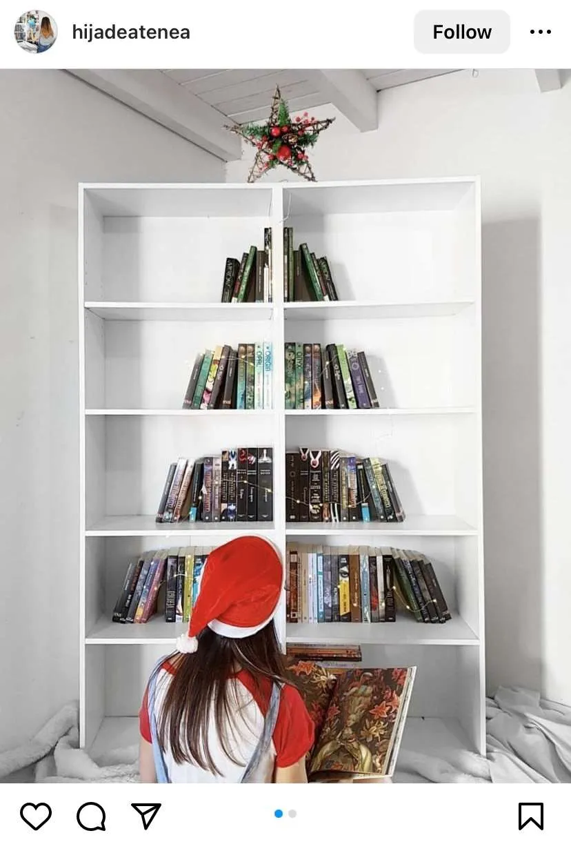 Bookmas tree ideas: books on bookshelf made to look like a Christmas tree.