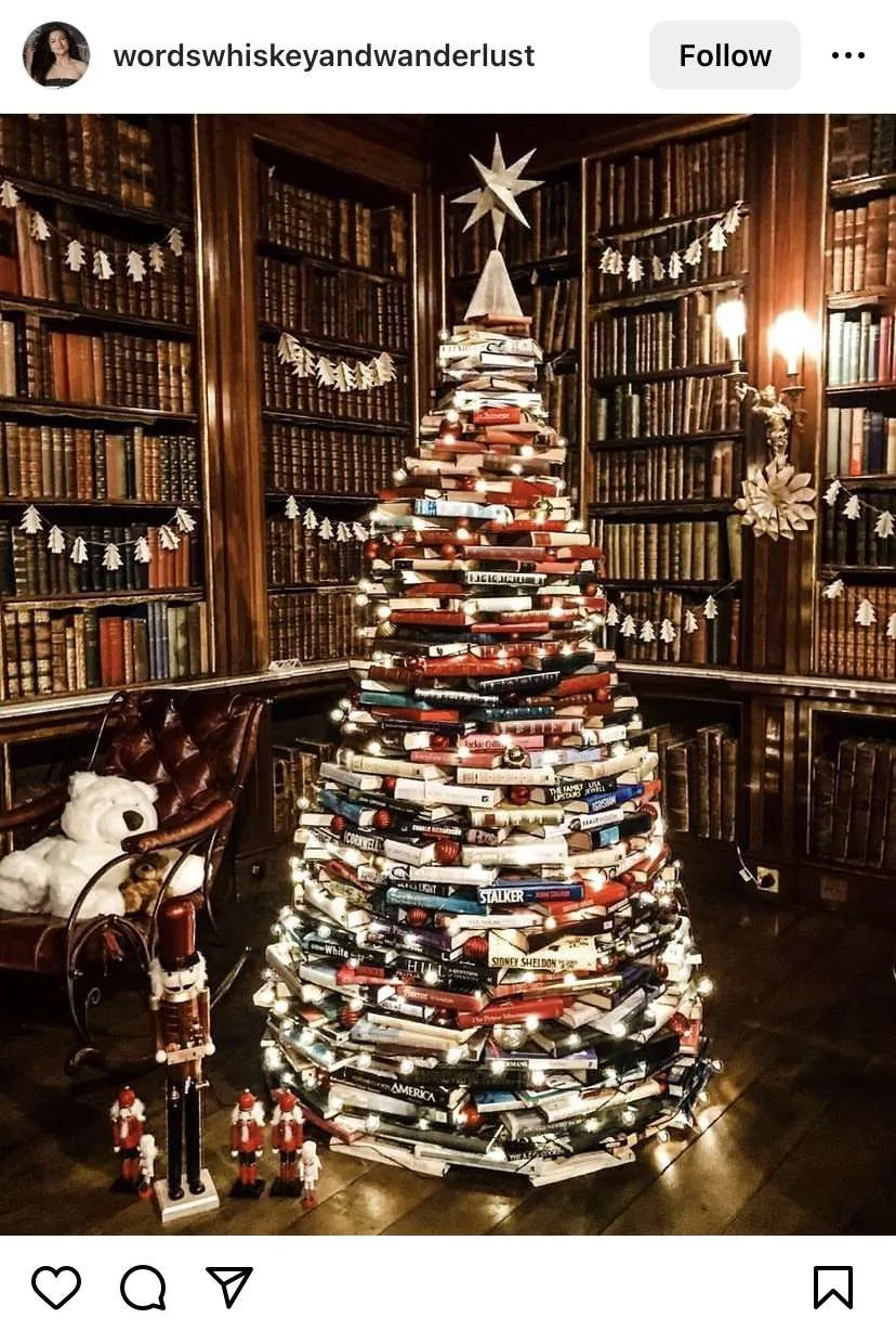 Bookmas tree: a big circular stack of books decorated to look like a Christmas tree