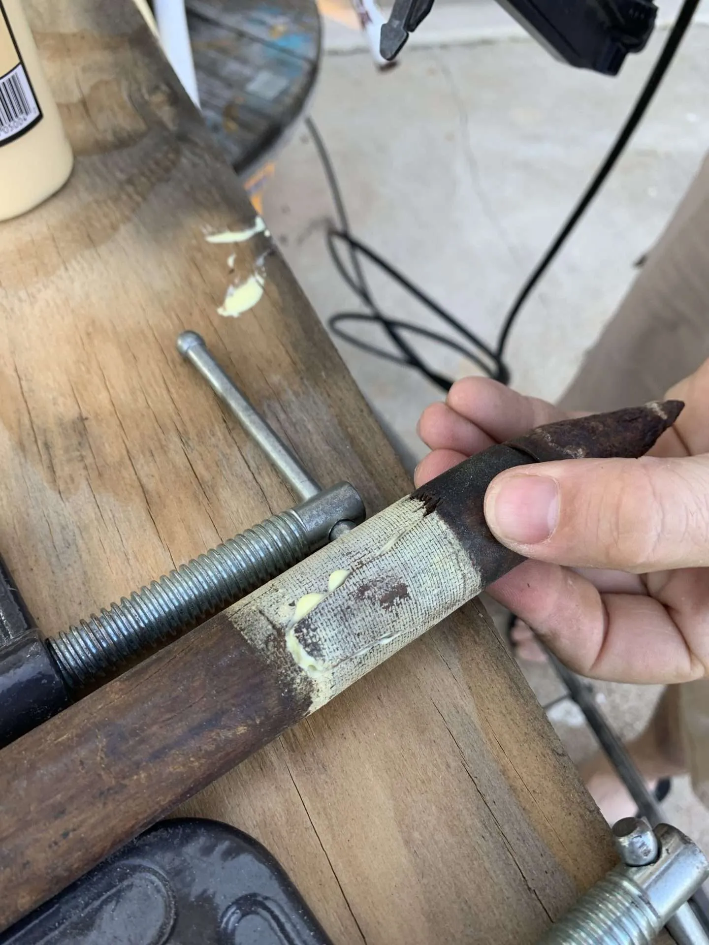 Repairing the broken leg of a tripod lamp.