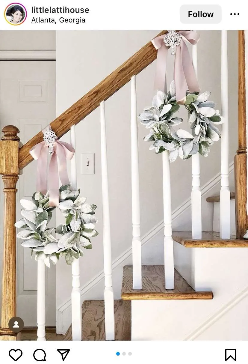 this Christmas staircase is decorated very simply with wreaths