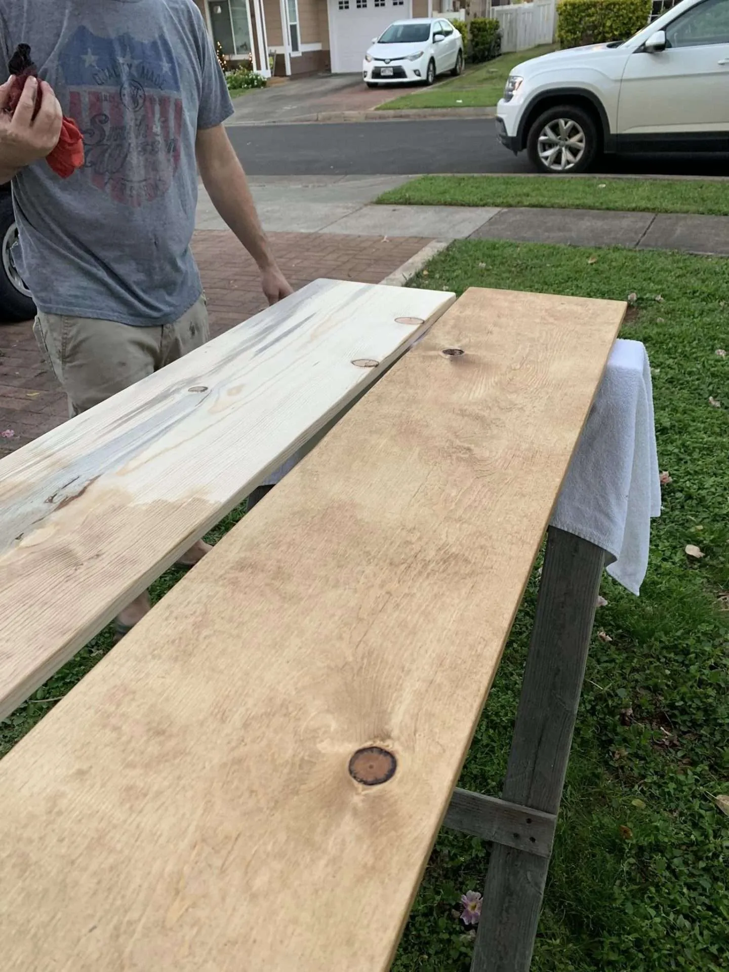 Staining the wood for our DIY open bookshelves.